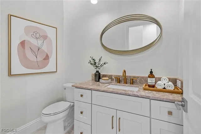 a bathroom with a toilet a sink and a mirror
