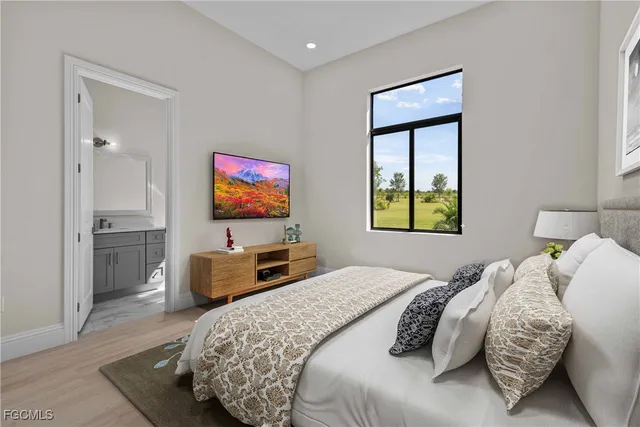 a bedroom with a bed and a flat screen tv