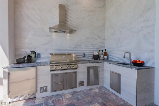 a kitchen with stainless steel appliances granite countertop a stove and a sink