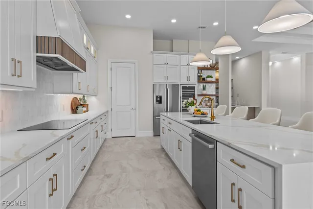a large kitchen with stainless steel appliances kitchen island granite countertop a sink and cabinets