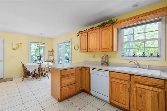 a kitchen with a sink window and cabinets