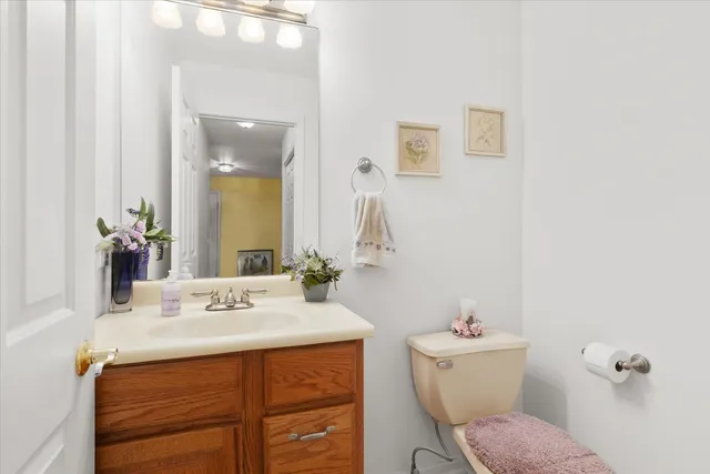 a bathroom with a sink toilet and mirror