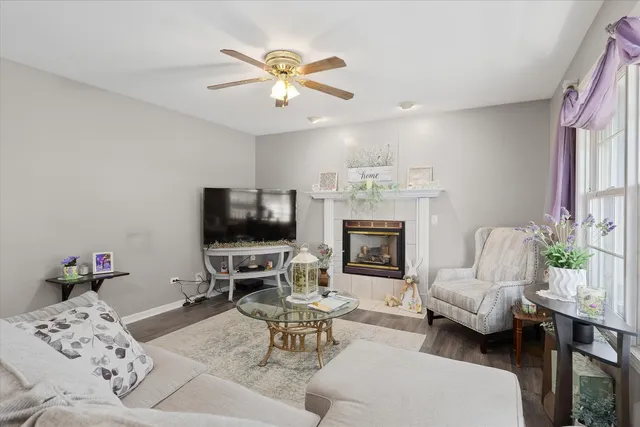 a living room with furniture a fireplace and a flat screen tv