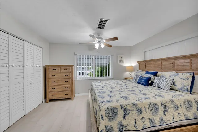 a bedroom with a large bed and a window