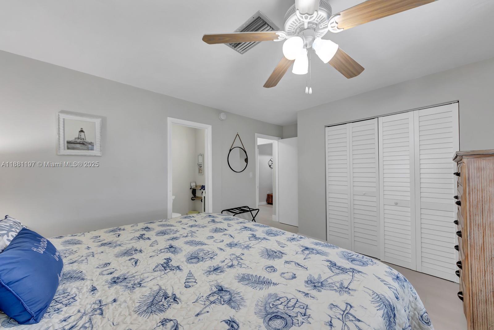 308 Sombrero Beach Road Marathon, FL 33050 - Photo 18 of 43 a bedroom with a bed and a chandelier