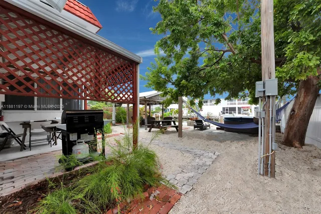 a view of a patio with table and chairs and potted plants