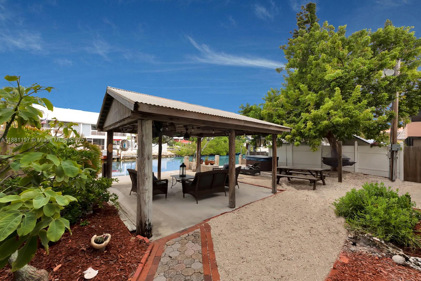 308 Sombrero Beach Road Marathon, FL 33050 - Photo 22 of 43 a backyard of a house with table and chairs