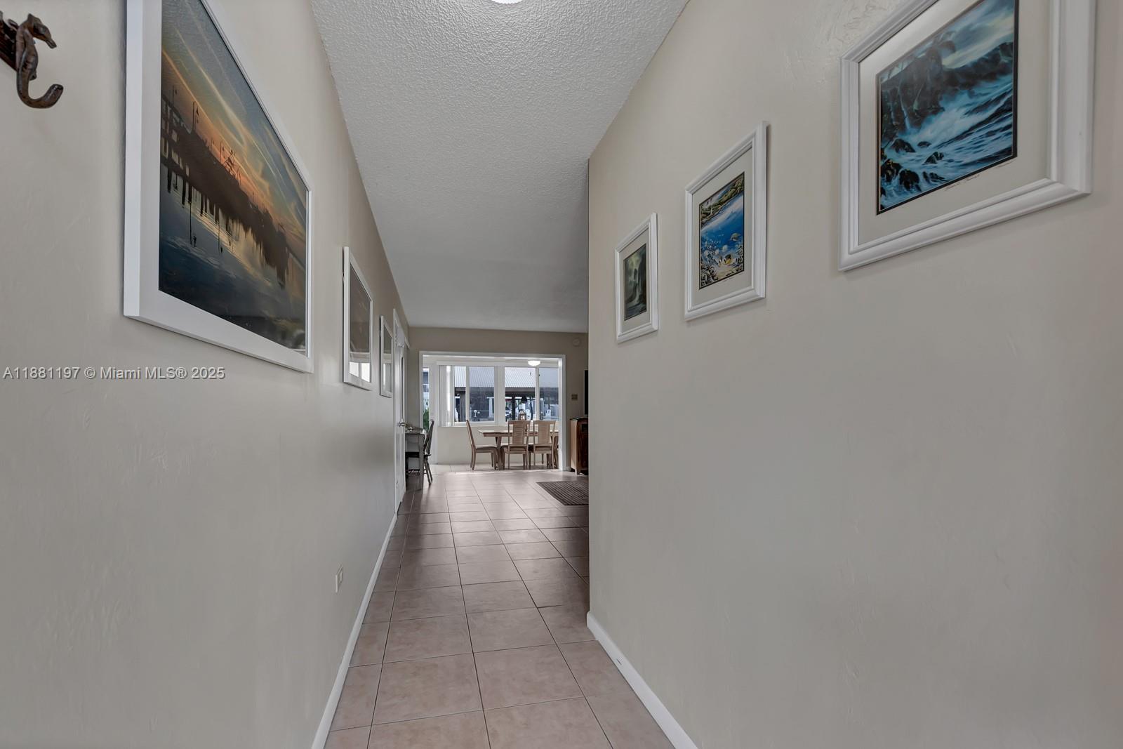 308 Sombrero Beach Road Marathon, FL 33050 - Photo 25 of 43 a view of a hallway with paintings on the wall