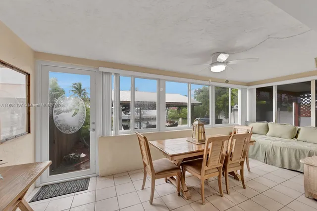 a dining room with furniture and large window