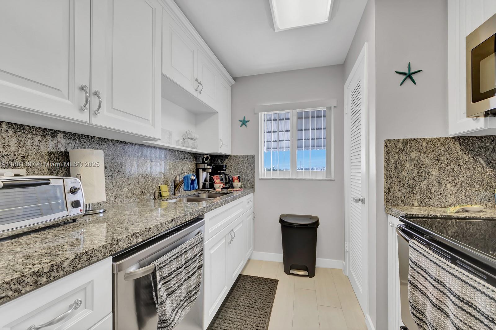 308 Sombrero Beach Road Marathon, FL 33050 - Photo 10 of 43 a kitchen with stainless steel appliances granite countertop a sink and a stove