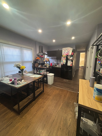 5749 West 64th Place Chicago, IL 60638 - Photo 6 of 12 a kitchen that has a lot of cabinets a sink and a wooden floor