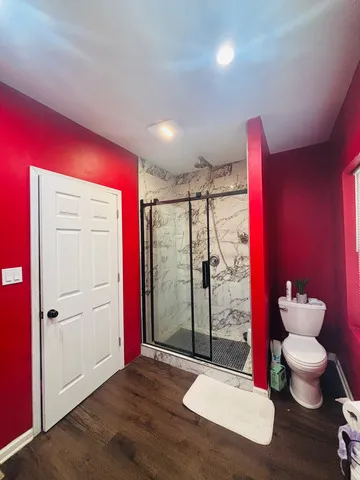 a bathroom with a toilet tub and shower