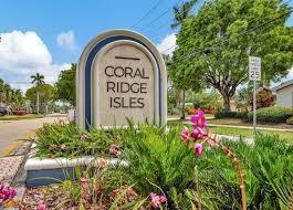 5201 Northeast 14th Terrace, Unit 3 Fort Lauderdale, FL 33334 - Photo 11 of 11 a view of a sign board with flower plants and wooden fence