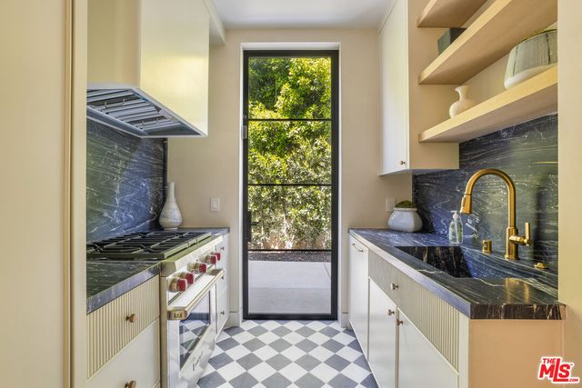 a kitchen with a sink and a stove top oven