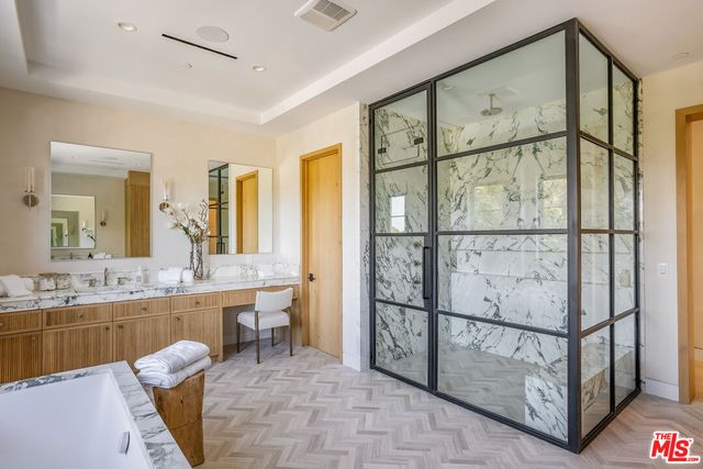 a bathroom with a granite countertop sink a next to a window