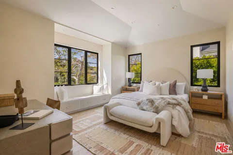 a spacious bedroom with a bed and a couch