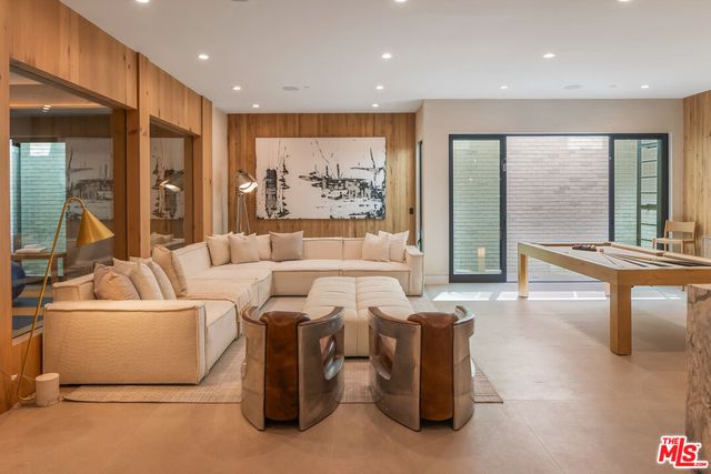 a living room with fireplace furniture and a large window