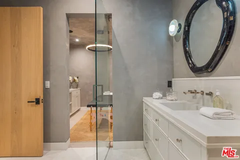 a bathroom with a sink vanity and a mirror