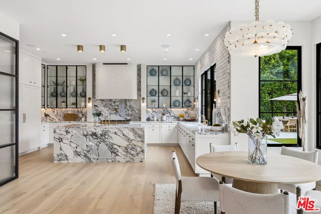 a large kitchen with furniture a large window and kitchen view