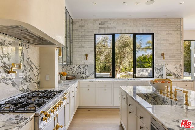 a kitchen with a sink a stove and a wooden cabinets