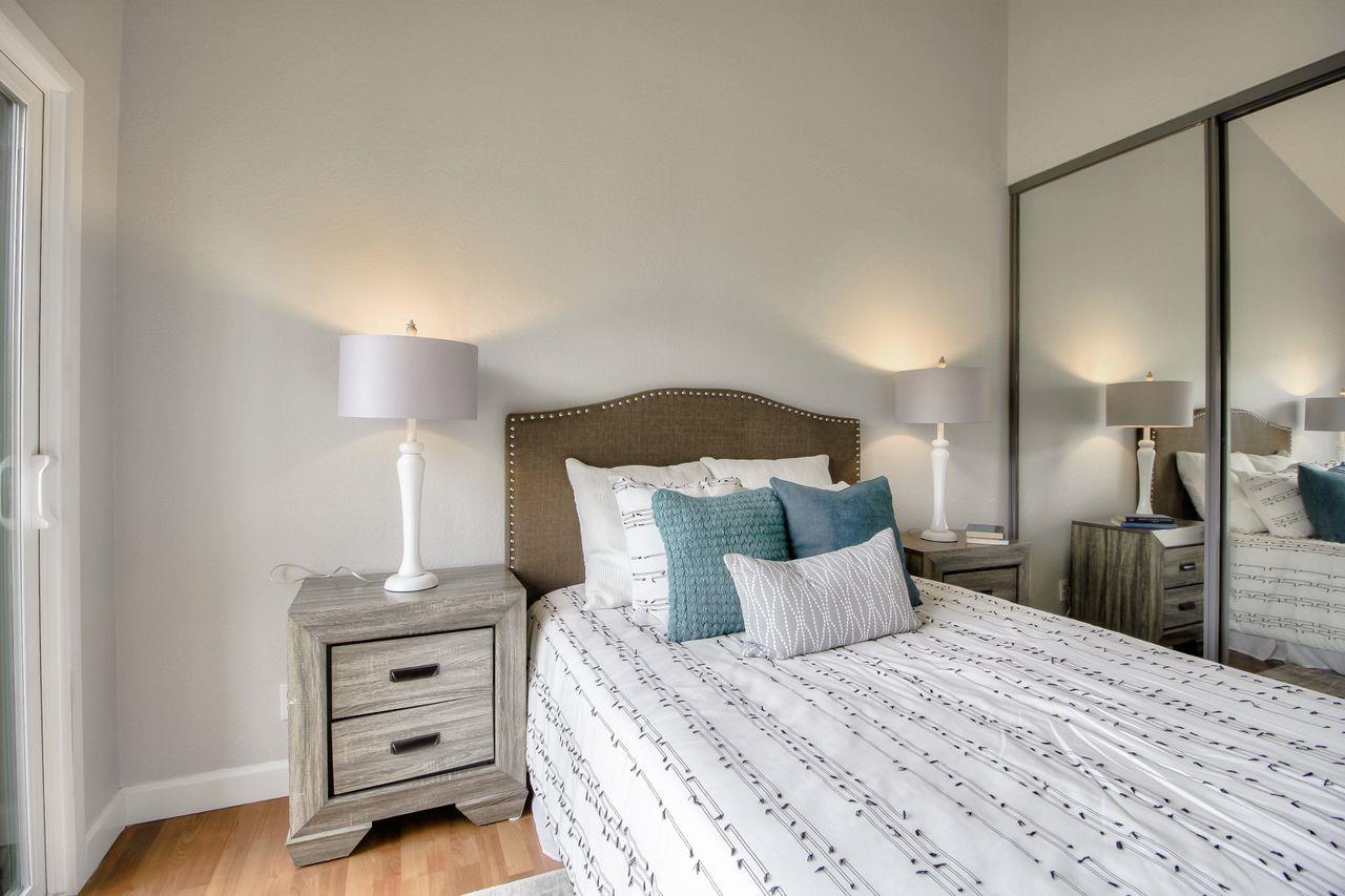 207 Monterey Road, Unit 7 Pacifica, CA 94044 - Photo 18 of 34 a bed room with a bed and a night stand