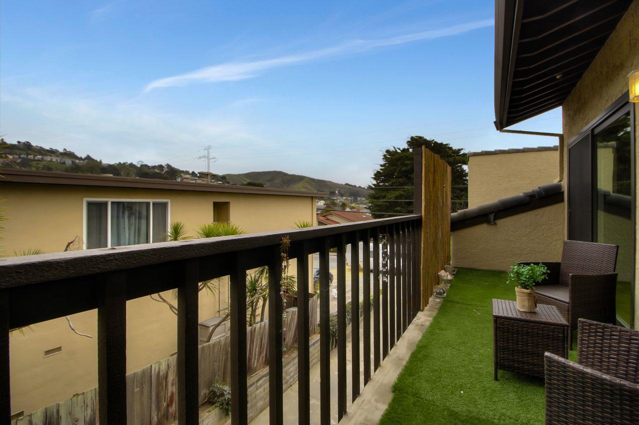207 Monterey Road, Unit 7 Pacifica, CA 94044 - Photo 20 of 34 a view of a balcony with chair and wooden floor