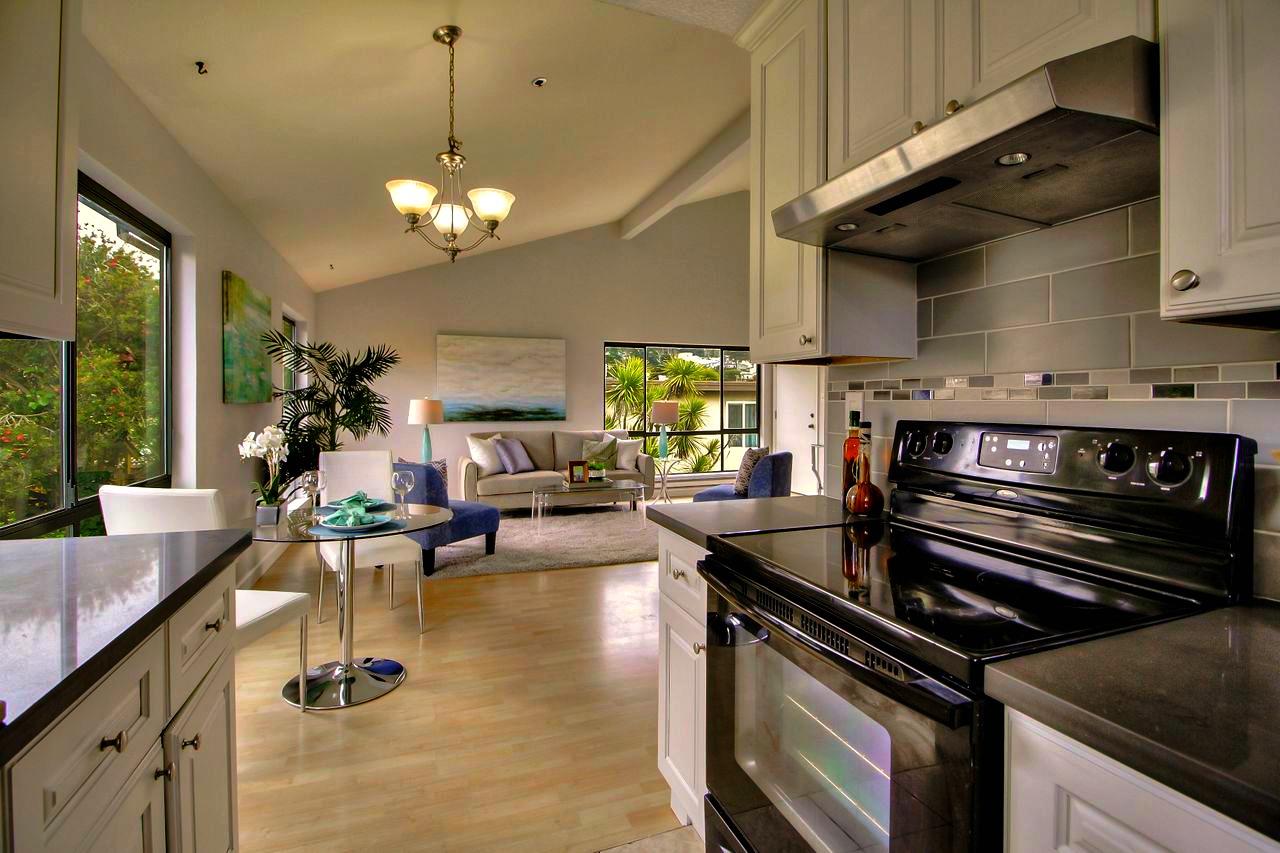 207 Monterey Road, Unit 7 Pacifica, CA 94044 - Photo 4 of 34 a kitchen with a stove and a chandelier