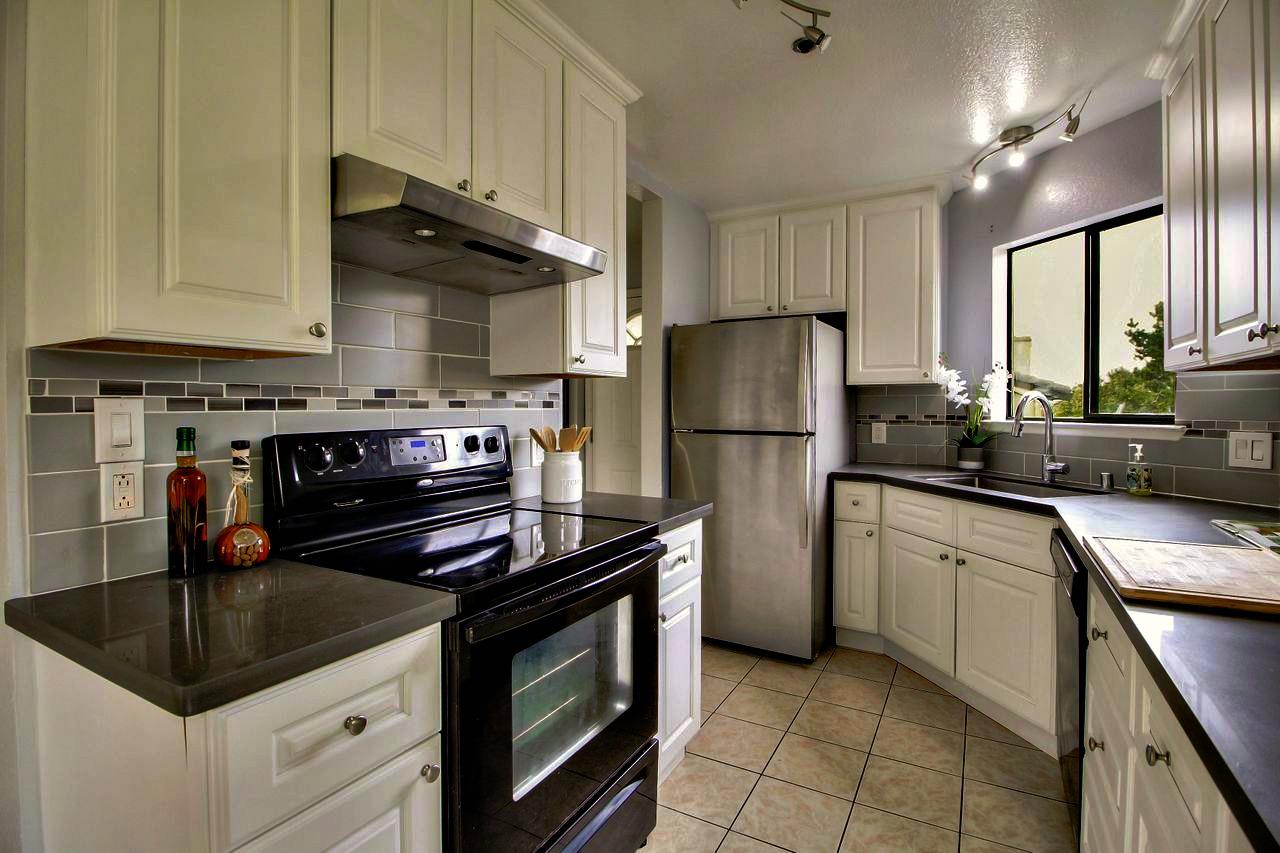 207 Monterey Road, Unit 7 Pacifica, CA 94044 - Photo 5 of 34 a kitchen with a stove cabinets and refrigerator