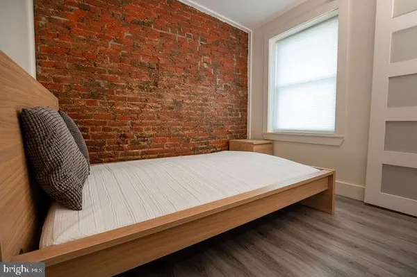 a bed sitting in a bedroom next to a window
