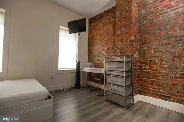 a room with a wooden floor and white walls