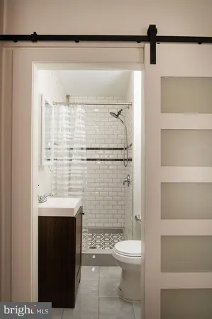 a bathroom with a shower toilet and sink