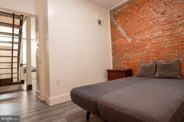 a bed sitting in a bedroom next to a window