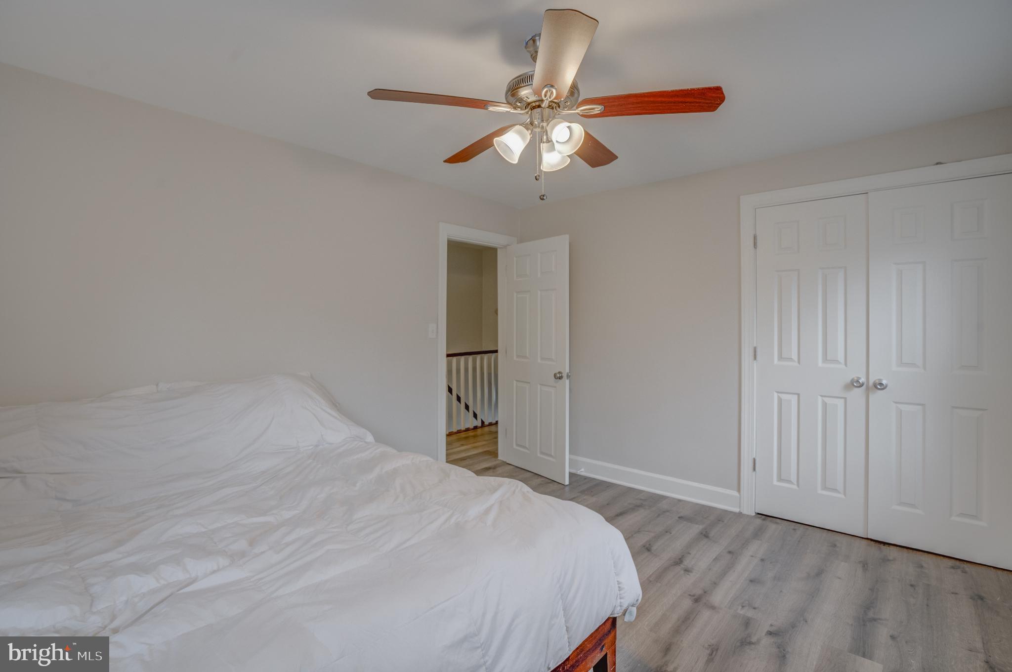 4814 Briarclift Road Baltimore, MD 21229 - Photo 15 of 34 a bedroom with a bed and a chandelier