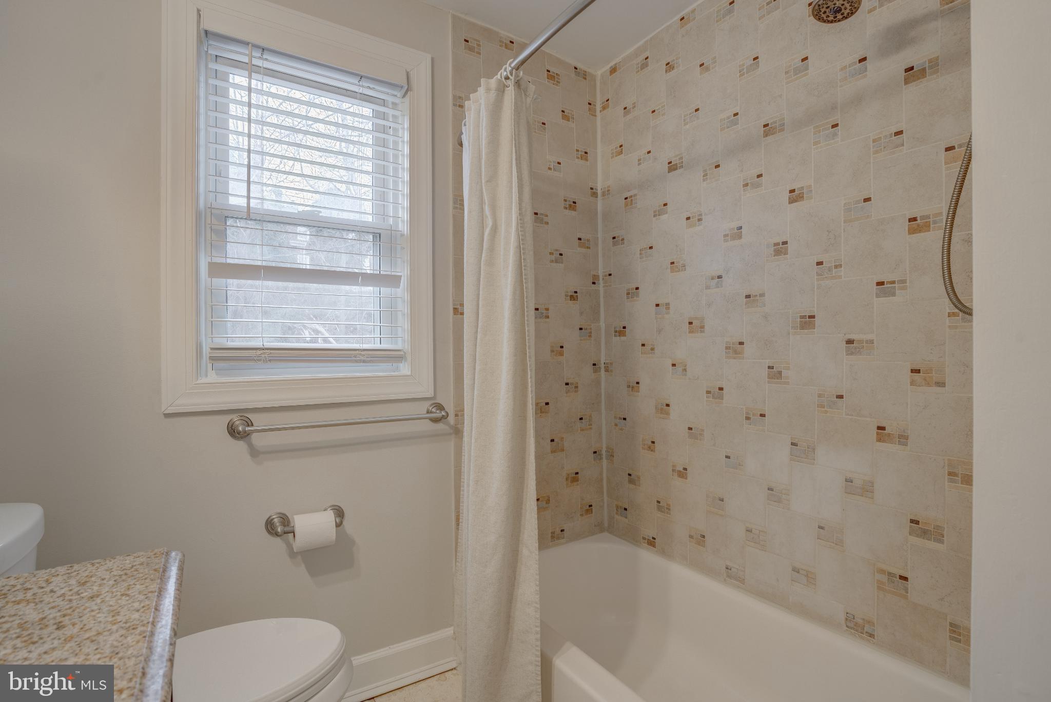 4814 Briarclift Road Baltimore, MD 21229 - Photo 17 of 34 a bath room with a toilet and a bath tub