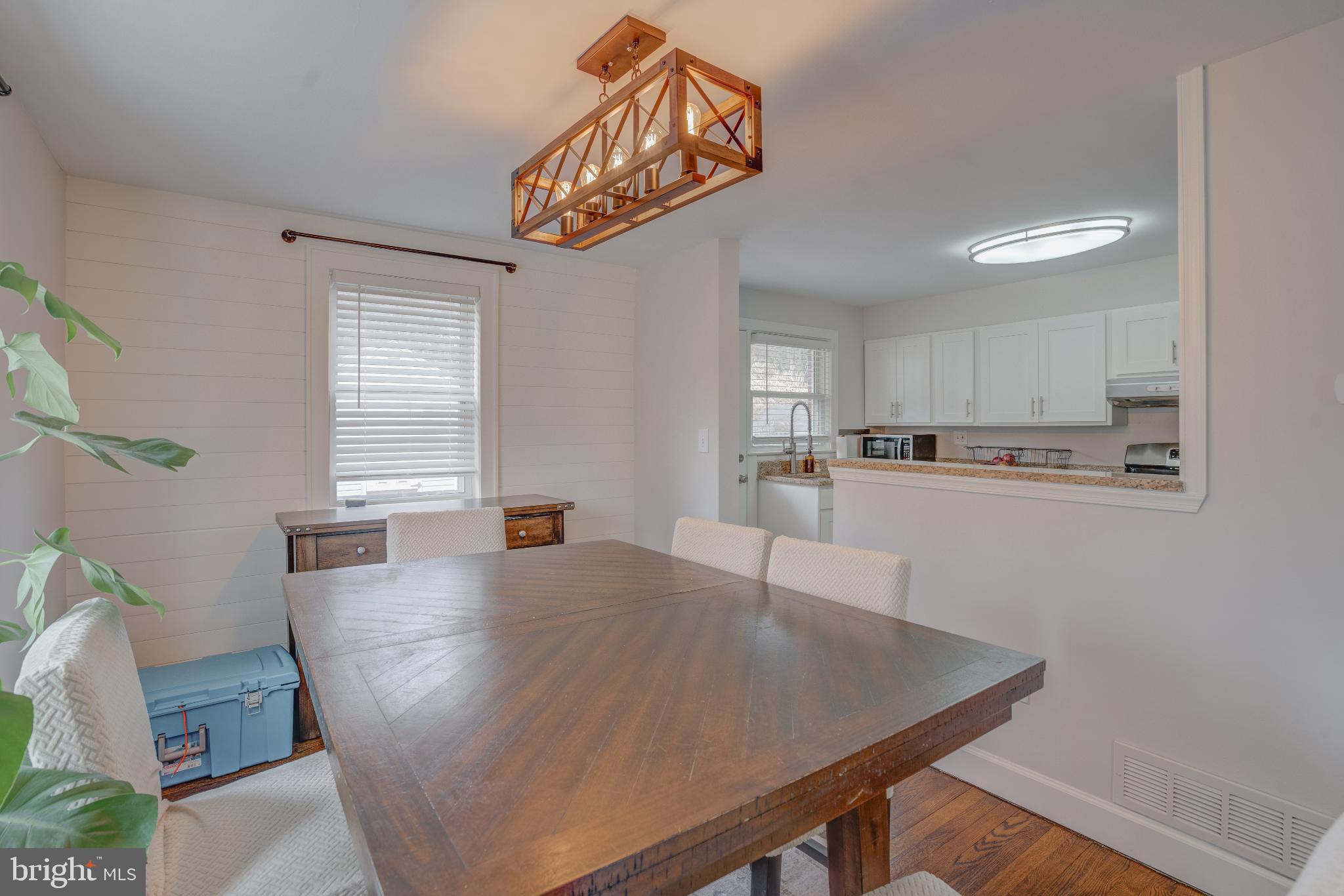 4814 Briarclift Road Baltimore, MD 21229 - Photo 6 of 34 a kitchen with stainless steel appliances a table chairs in it and wooden floor