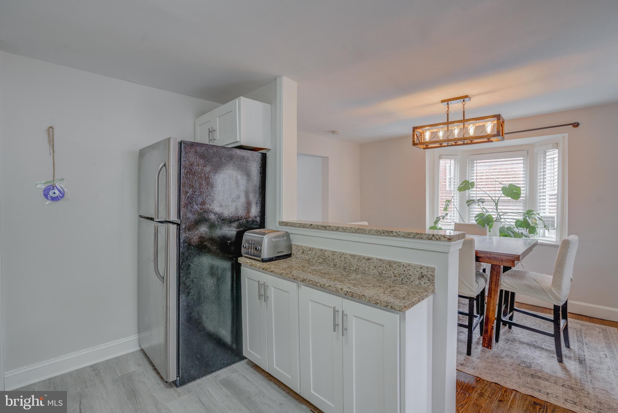 4814 Briarclift Road Baltimore, MD 21229 - Photo 9 of 34 a kitchen with stainless steel appliances granite countertop furniture and a refrigerator