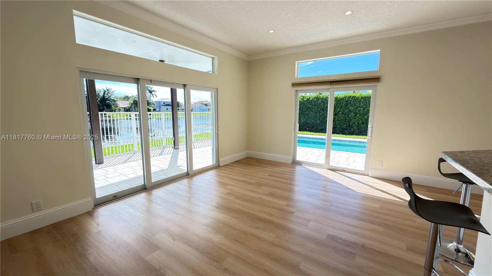 4221 Laurel Ridge Circle Weston, FL 33331 - Photo 15 of 57 a view of an empty room with wooden floor and a window
