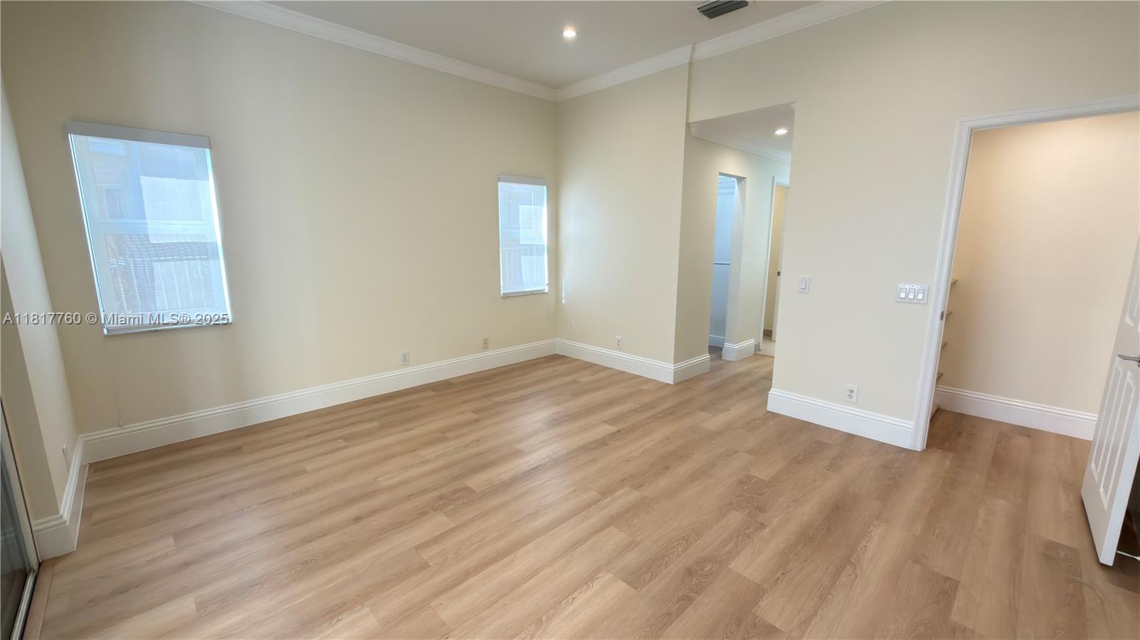 4221 Laurel Ridge Circle Weston, FL 33331 - Photo 18 of 57 an empty room with wooden floor and a window
