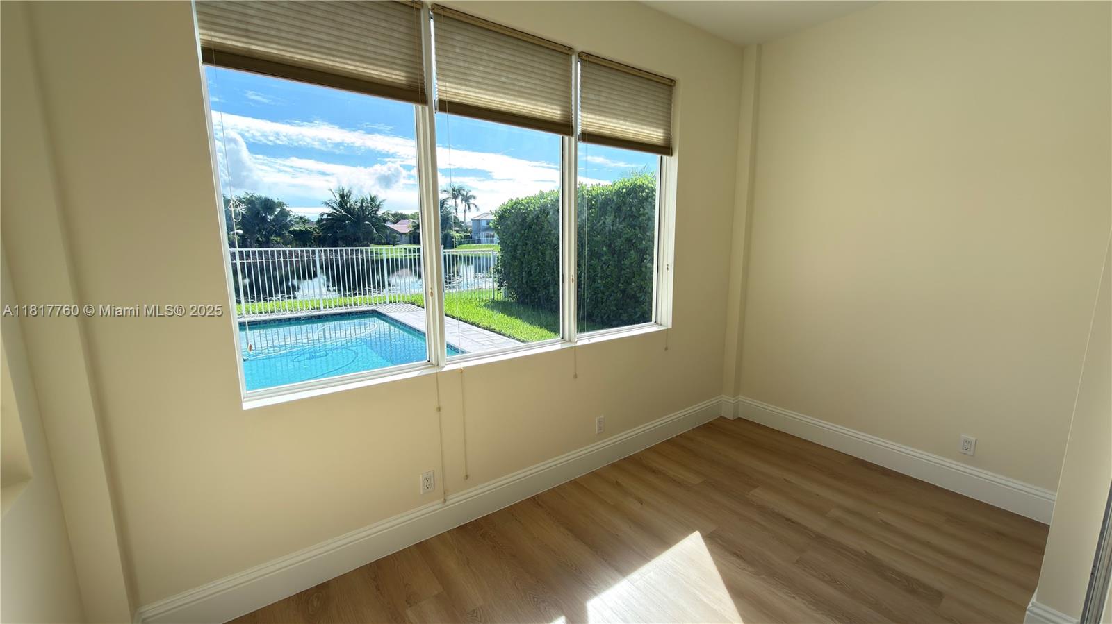 4221 Laurel Ridge Circle Weston, FL 33331 - Photo 19 of 57 a view of a room with wooden floor and a window
