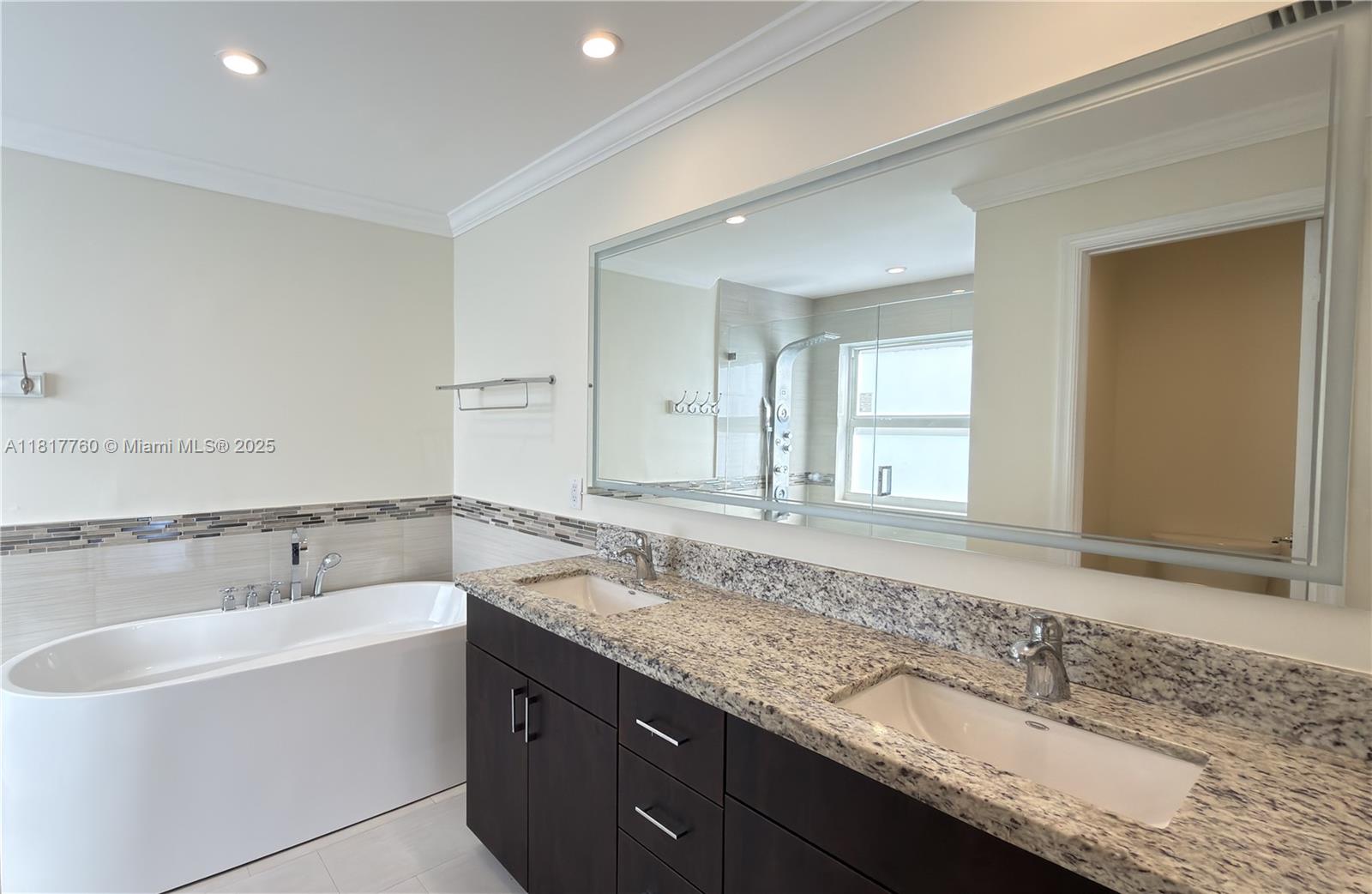 4221 Laurel Ridge Circle Weston, FL 33331 - Photo 21 of 57 a bathroom with a granite countertop sink and a bathtub