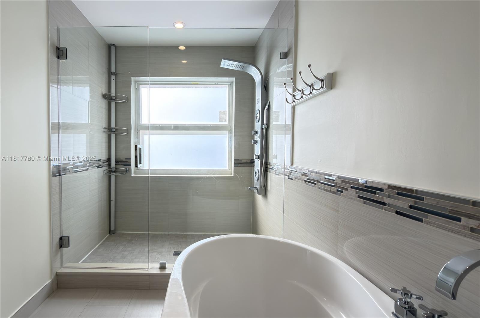 4221 Laurel Ridge Circle Weston, FL 33331 - Photo 23 of 57 a bathroom with a bathtub and a shower