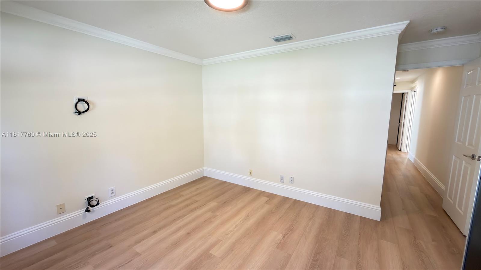 4221 Laurel Ridge Circle Weston, FL 33331 - Photo 27 of 57 an empty room with wooden floor and entrance