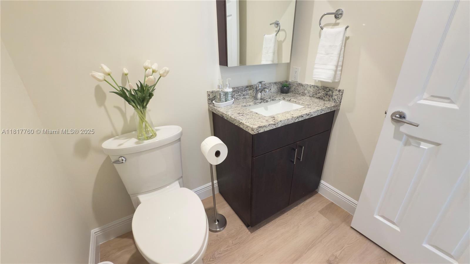 4221 Laurel Ridge Circle Weston, FL 33331 - Photo 36 of 57 a bathroom with a toilet sink and mirror