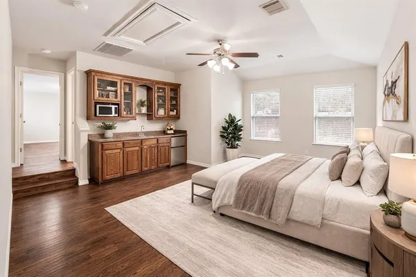 a bedroom with a large bed and a chandelier