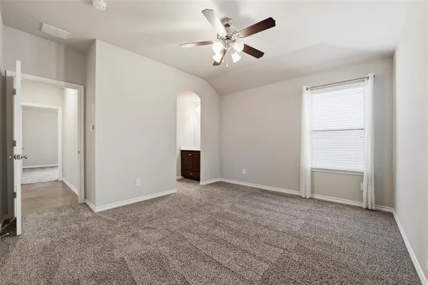 an empty room with closet and windows