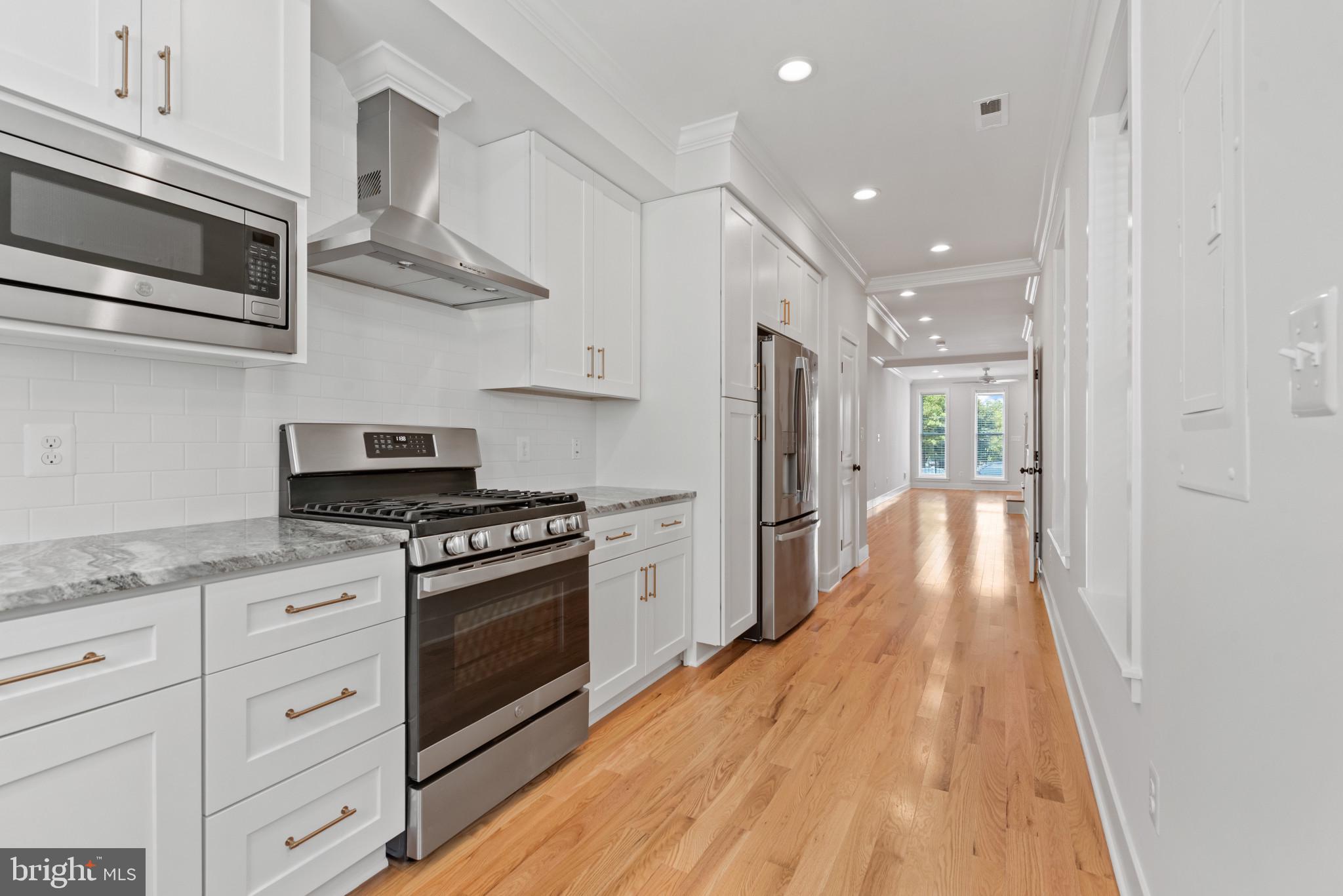 1005 Riverside Avenue Baltimore, MD 21230 - Photo 11 of 29 a kitchen with stainless steel appliances granite countertop a stove a refrigerator and a microwave