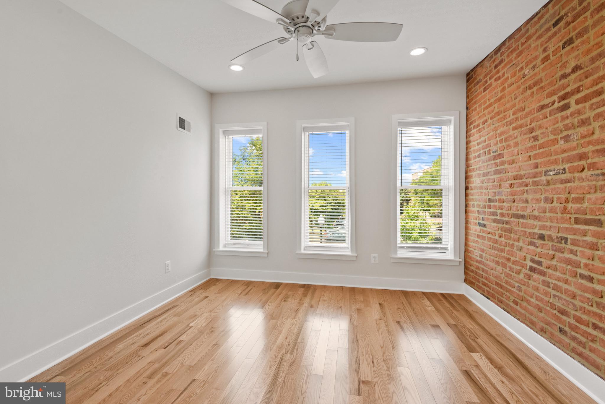 1005 Riverside Avenue Baltimore, MD 21230 - Photo 17 of 29 wooden floor in an empty room with a window
