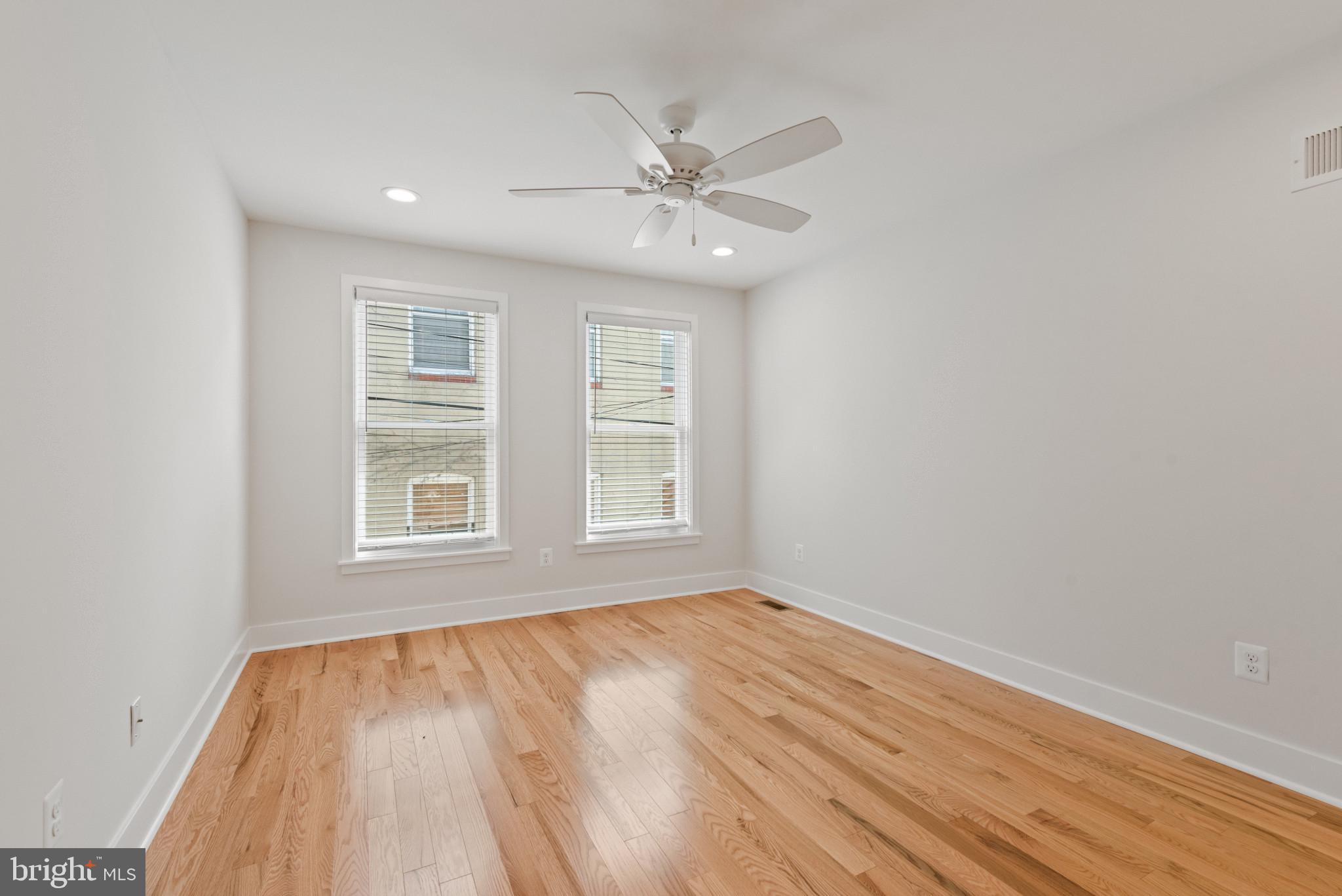 1005 Riverside Avenue Baltimore, MD 21230 - Photo 22 of 29 a view of an empty room with wooden floor and a window