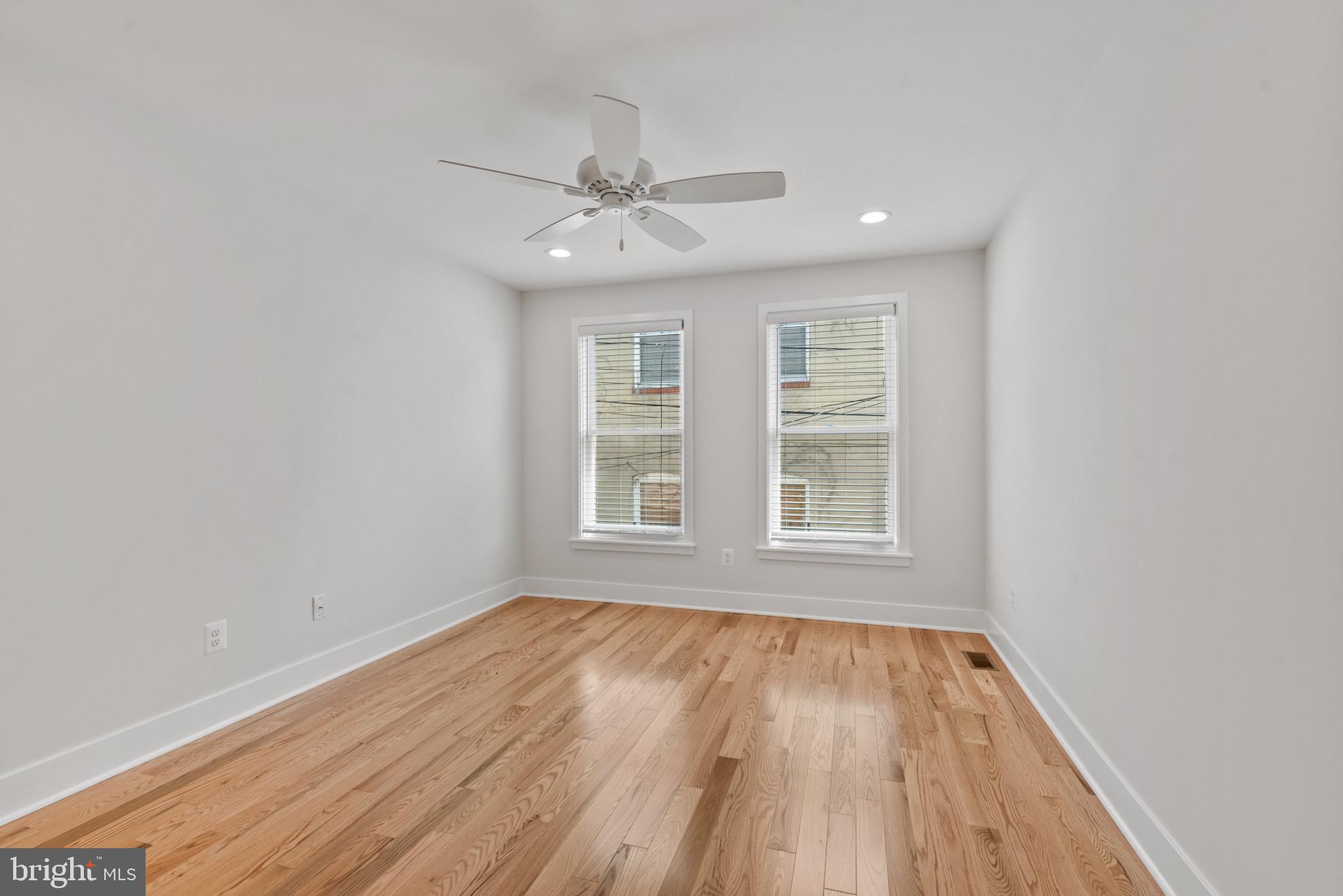 1005 Riverside Avenue Baltimore, MD 21230 - Photo 23 of 29 a view of an empty room with wooden floor and a window