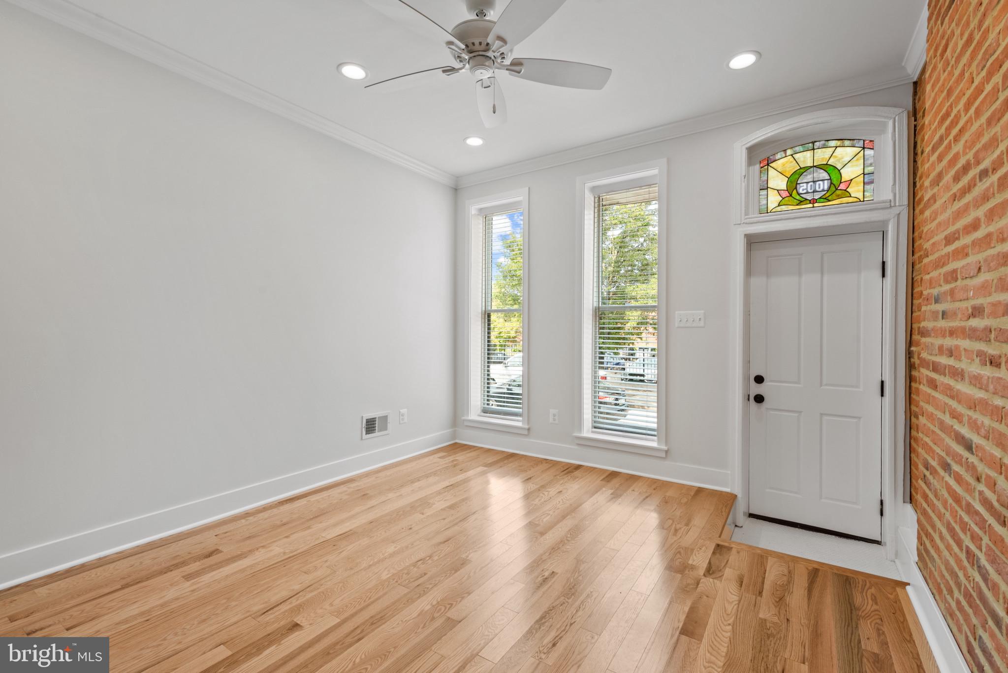 1005 Riverside Avenue Baltimore, MD 21230 - Photo 5 of 29 a view of an empty room with window and wooden floor